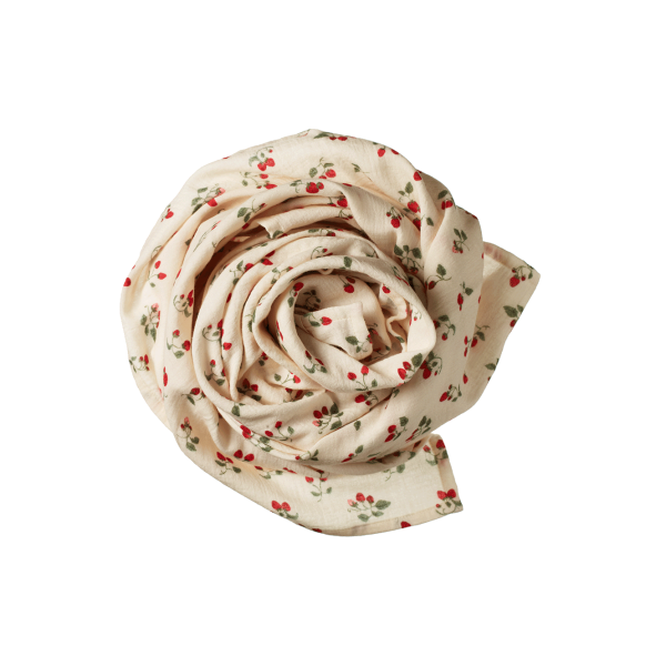 Rolled-up muslin blanket with strawberry pattern on a white background