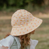 Side view of girl wearing BEDHEAD HATS Ponytail Bucket Sun Hat - Butterfly