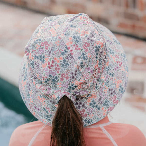 Back view of girl wearing BEDHEAD HATS Ponytail Swim Bucket Beach Hat - Blossom