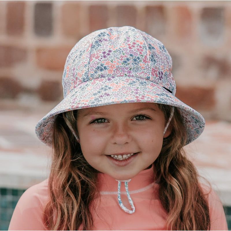 Girl wearing BEDHEAD HATS Ponytail Swim Bucket Beach Hat - Blossom