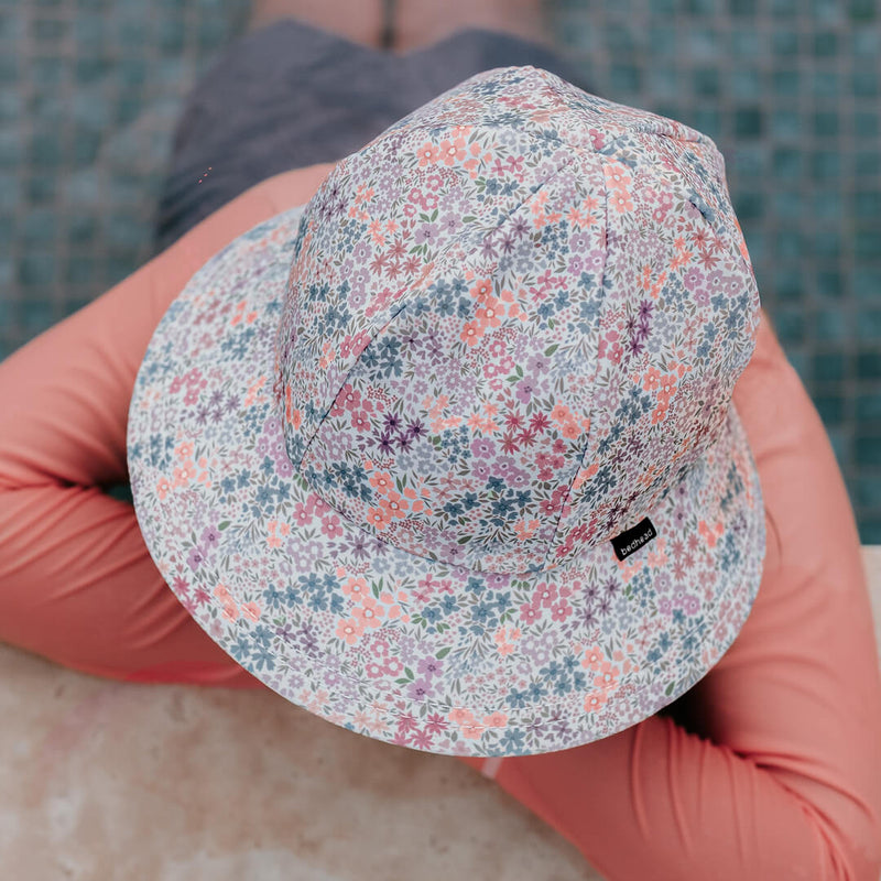 Top view of child wearing BEDHEAD HATS Ponytail Swim Bucket Beach Hat - Blossom