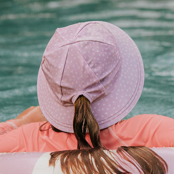 Back view of girl wearing BEDHEAD HATS Ponytail Swim Bucket Beach Hat - Lila