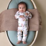 Baby lying in bassinet wearing SNUGGLE HUNNY Farm Organic Snugglesuit Convertible Romper