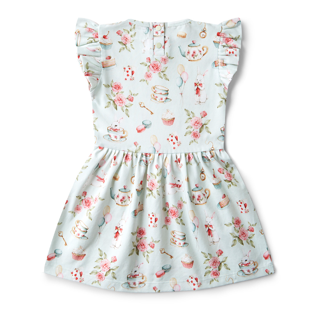 Back view of Children's dress with floral and tea party pattern on a white background