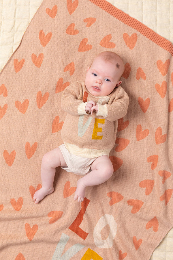 Baby lying on the Baby in a bassinet covered with the INDUS DESIGN Love Heart Baby Blanket