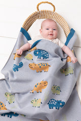 Baby in a bassinet covered with the INDUS DESIGN Henry Hippo Baby Blanket