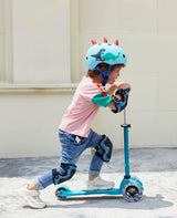 Child riding the MICRO SCOOTERS Mini Micro Deluxe LED - Aqua