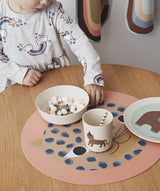 CHILD USING THE 70010485 OYOY SNOW LEOPARD PLACEMAT 