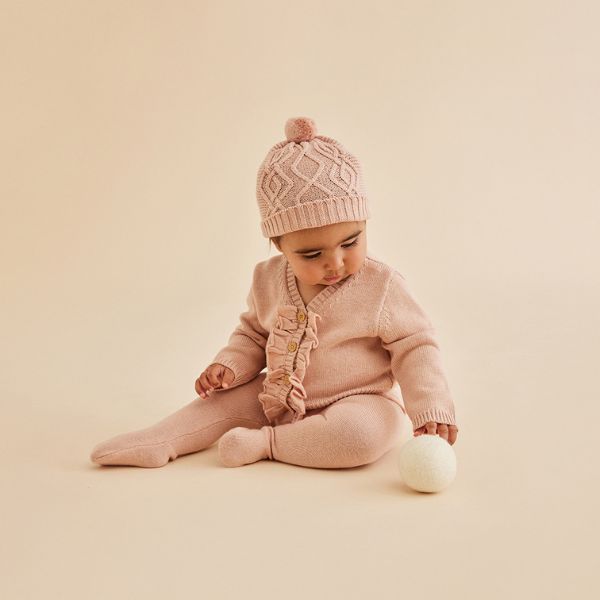 Baby wearing the WILSON & FRENCHY Knitted Cable Hat - Rose
