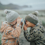 Kids playing outside wearing the Alpine beanies in Moss & Khaki - side view