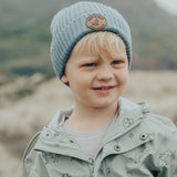 Child outside wearing the CRYWOLF Pom Pom Beanie - Scout Blue 