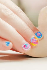 Child wearing TOi nail stickers