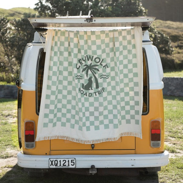 CRYWOLF Supersized Square Towel - Seagrass Checkered hanging off the back of a kombi