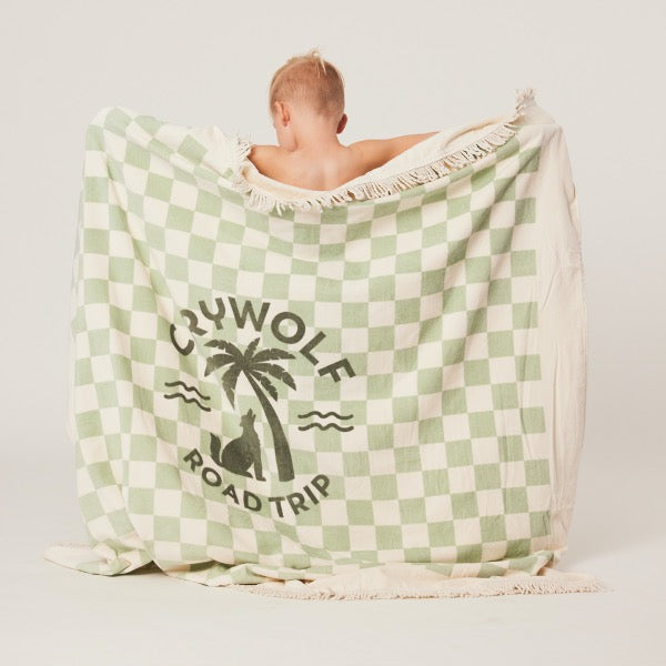 Child holding the CRYWOLF Supersized Square Towel - Seagrass Checkered