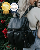 Lady wearing the OiOi Faux Leather Nappy Backpack - Black