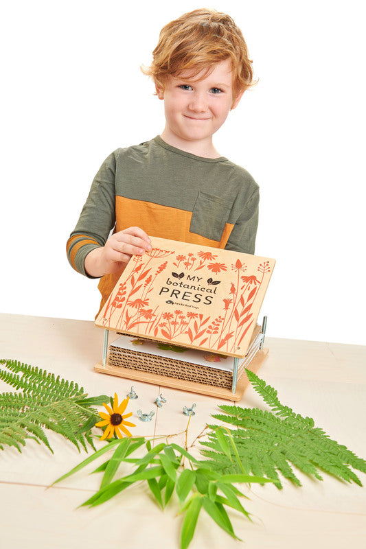 Child playing with the TENDER LEAF My Botanical Flower Press
