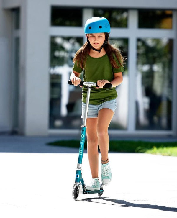 Child riding Micro Sprite Light Up Scooter - Sea Green