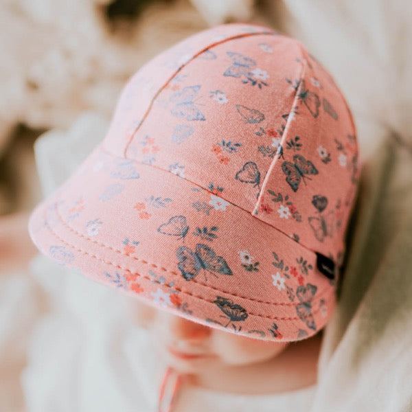 Baby wearing the BEDHEAD HATS Legionnaire Flap Sun Hat - Butterfly top view